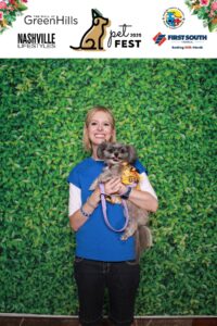 A lady smiling for a photo with her dog at Pet Fest 2025