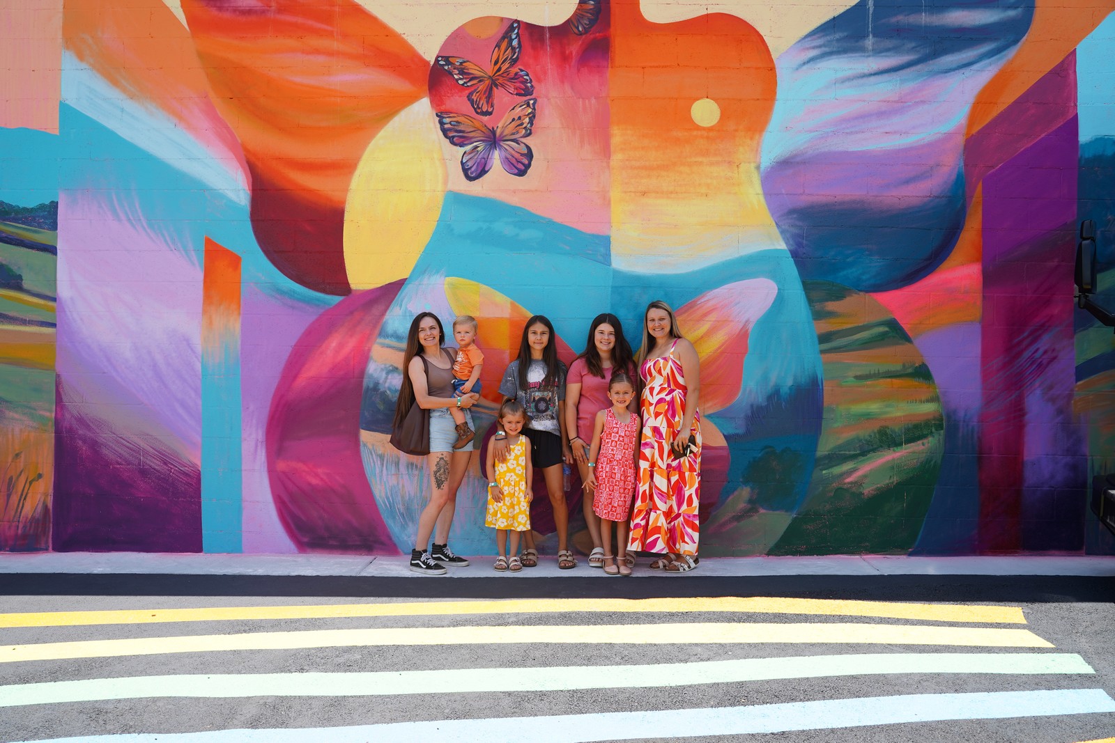 Family portrait in front of Britt Flood's mural