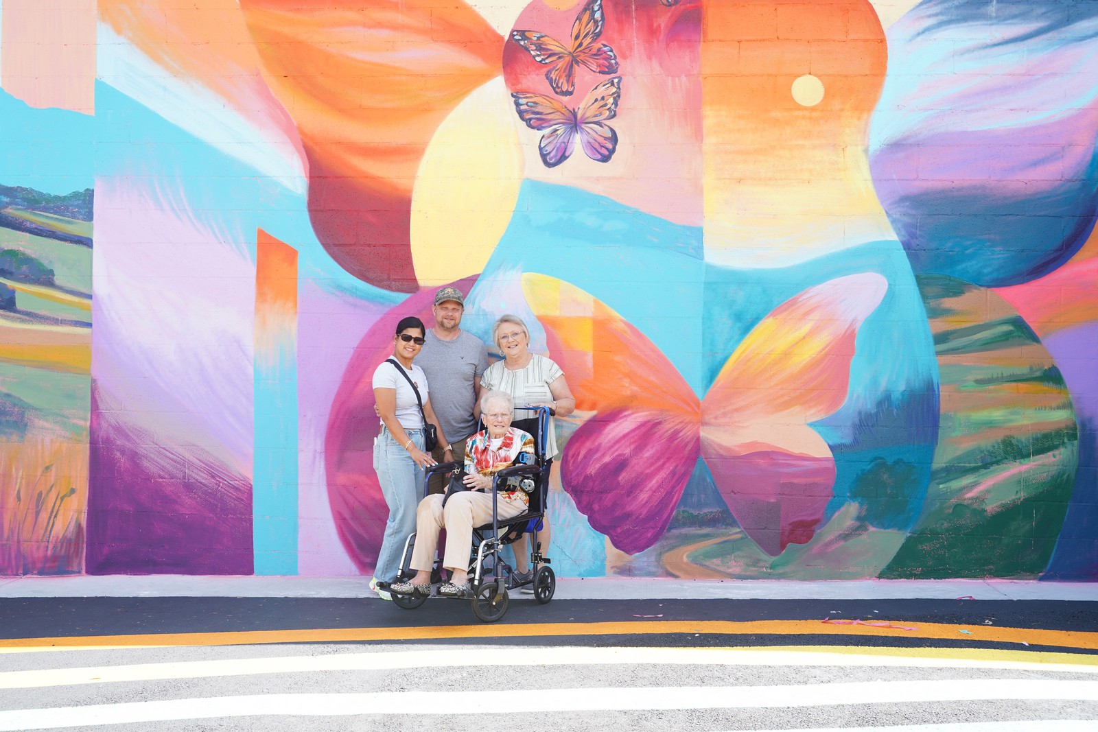 Visitors posing beside the Dolly-inspired tour bus